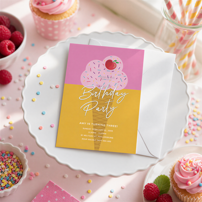 A birthday party invitation for a girl named Amy, who is turning three, with details about the party on a white card with a pink and yellow background. The invitation is placed on a white plate, surrounded by various desserts, such as cupcakes, raspberries, and sprinkles.