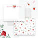 a white envelope with a floral pattern and a red rose, along with some red rose petals and a red rose clip on a white background.