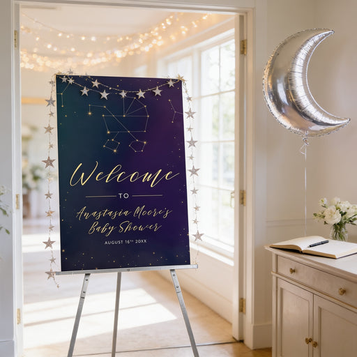 a sign welcoming guests to a baby shower, with a crescent moon decoration and stars on the sign. The sign is placed in a room with a window and a table with flowers.