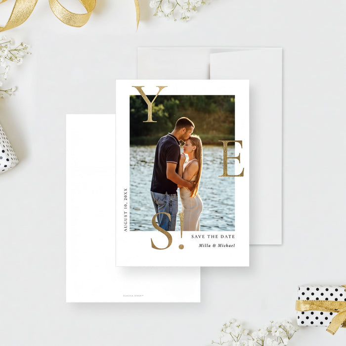 A wedding invitation featuring a couple embracing in front of a scenic background, with the text "Save the date" and the names "Milla & Michael" printed on it.