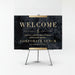 a black and gold sign with the text "Welcome to Smith Constructions and Partners' Corporate Lunch" on it.