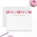 a white card with a personalized message, a pink donut, and a pen on a white background.