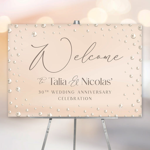 30th wedding anniversary welcome sign with pearl-inspired blush design, elegant script lettering, and personalized couple names displayed on an easel.