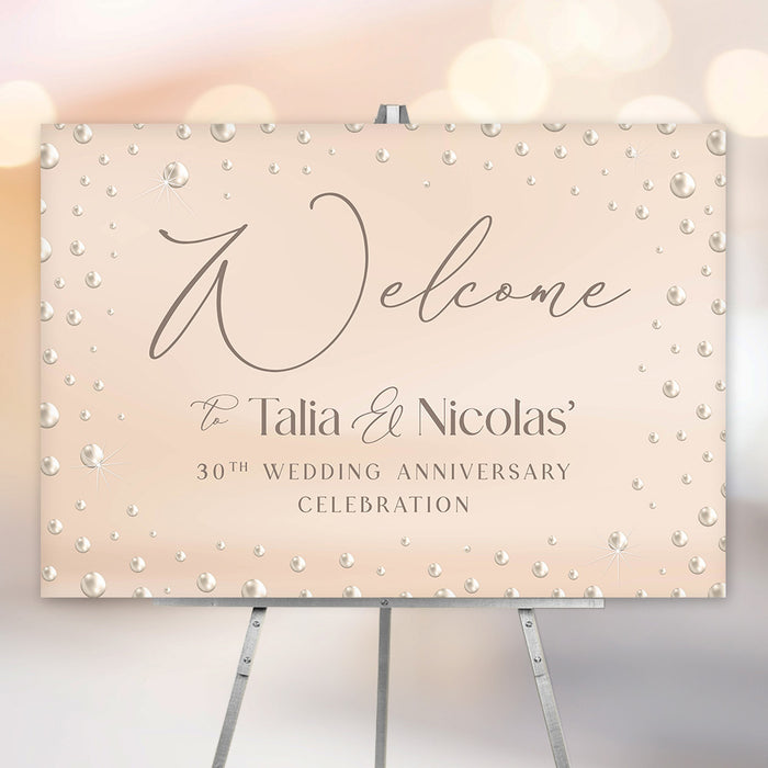 30th wedding anniversary welcome sign with pearl-inspired blush design, elegant script lettering, and personalized couple names displayed on an easel.