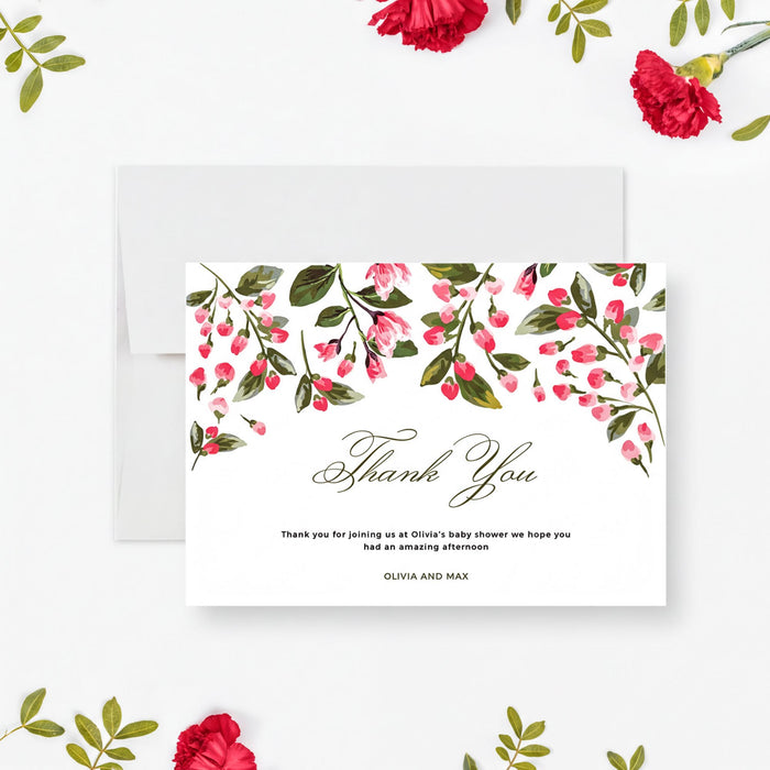a white card with a floral design and text, surrounded by red flowers and green leaves.