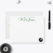 a personalized note card with the name "Martin Thompson" written on it, along with a pool ball and a pen.