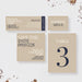 a set of event-related materials, including a ticket, a save-the-date card, and a table number card.