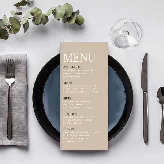 a table setting with a menu, silverware, and a glass of wine.