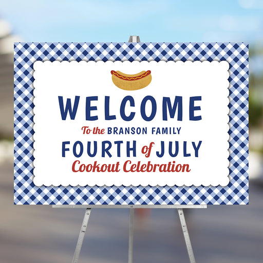 Fourth of July welcome sign with a blue gingham border and a hot dog bun illustration for a family cookout celebration