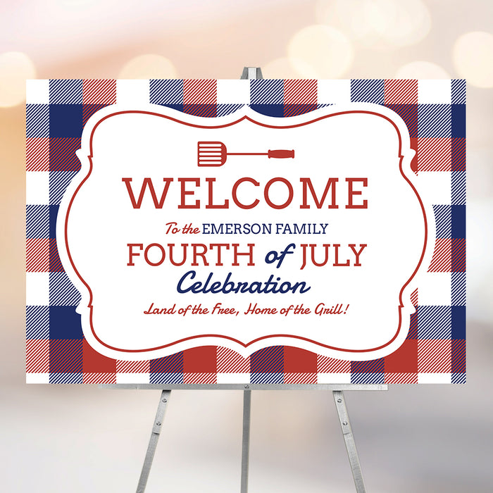 Fourth of July welcome sign with red, white, and blue plaid design and a grill spatula icon