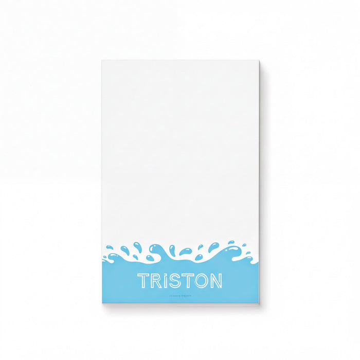 A white notepad with the word "TRISTON" written in blue text at the bottom.