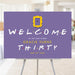 90s sitcom-inspired birthday party welcome sign with purple background, yellow frame detail, colorful dotted lettering, and personalized party details displayed on an easel