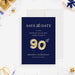 90th birthday save the date card with gold colored balloon numbers on a navy blue background.