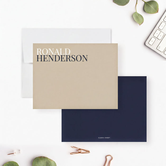 a beige envelope with the name "RONALD HENDRSON" printed on it, along with a dark blue envelope. The name "CLAIURA WENNING" is also visible on the dark blue envelope. The scene includes a keyboard, a pair of scissors, and some leaves, creating a professional and organized workspace.