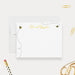 a white card with a personalized message, a pen, a stapler, and a pair of scissors on a white background.