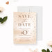 a save the date card with pearls on it