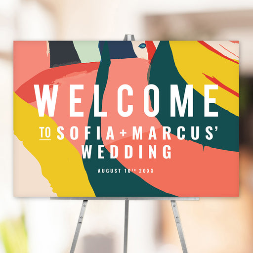 Colorful abstract wedding welcome sign with modern brushstroke design in bold colors, personalized with couple’s names and wedding date.