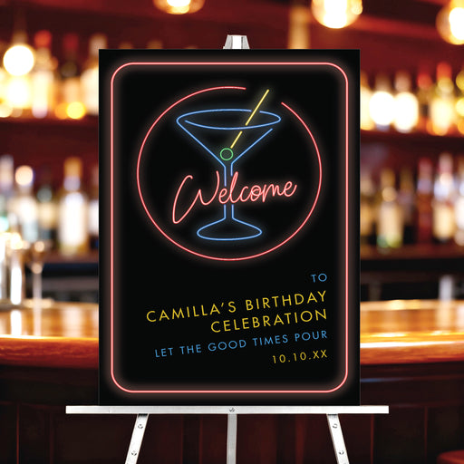 neon cocktail birthday welcome sign with glowing martini drink design displayed on easel in bar setting