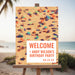 Personalized beach party welcome sign featuring aerial beach scene, umbrellas, and custom text for birthday or tropical celebration, displayed on easel.