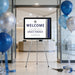 a welcome sign for the launch party of Grace Finance, with a backdrop of blue and silver balloons.