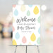 Colorful raindrops baby shower welcome sign for the mom-to-be, a cheerful party entrance decoration.