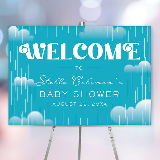 Baby shower welcome sign with a cloud and raindrop design on a blue background