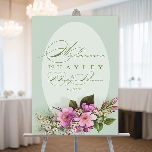 Personalized baby shower welcome sign featuring a sage green background with pink and white flowers, elegant floral decor for parties and event venues.