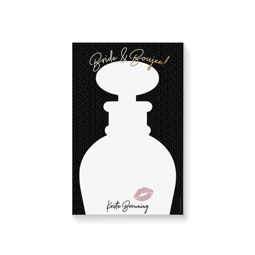 Personalized bachelorette notepad featuring perfume bottle silhouette with a pink lip print on a black geometric background with "Bride and Boujee" gold text.