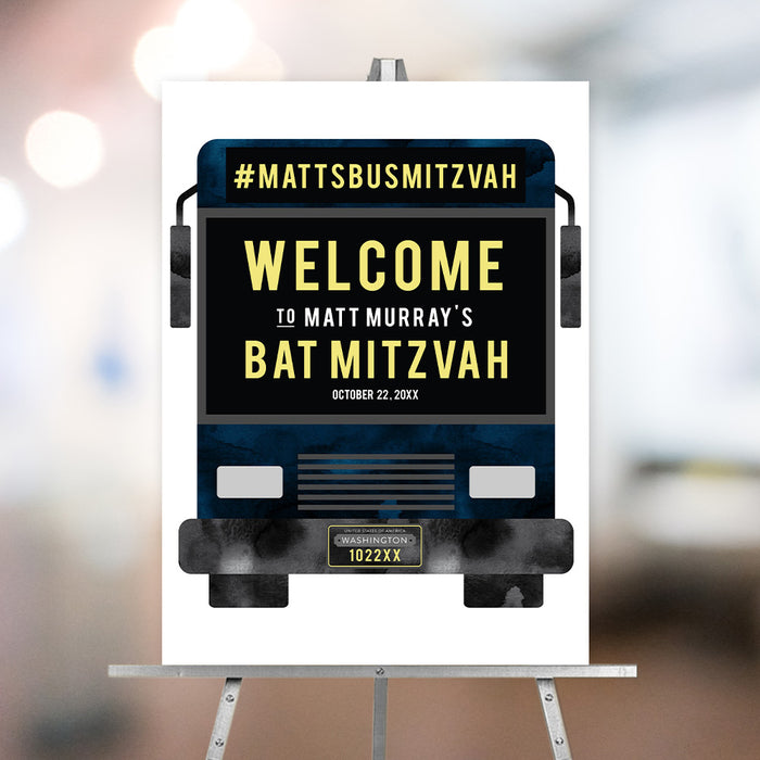 Bar mitzvah welcome sign featuring a party bus design with bold lettering displayed on an easel at event entrance