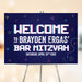 Gamer bar mitzvah welcome sign with pixel-style text, bright neon gaming icons, and dark blue video game theme design.
