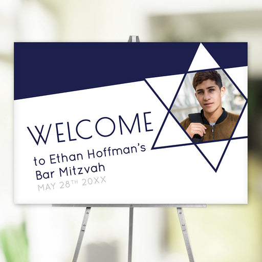 Personalized Bar Mitzvah welcome poster on easel with Star of David frame around boy’s photo.