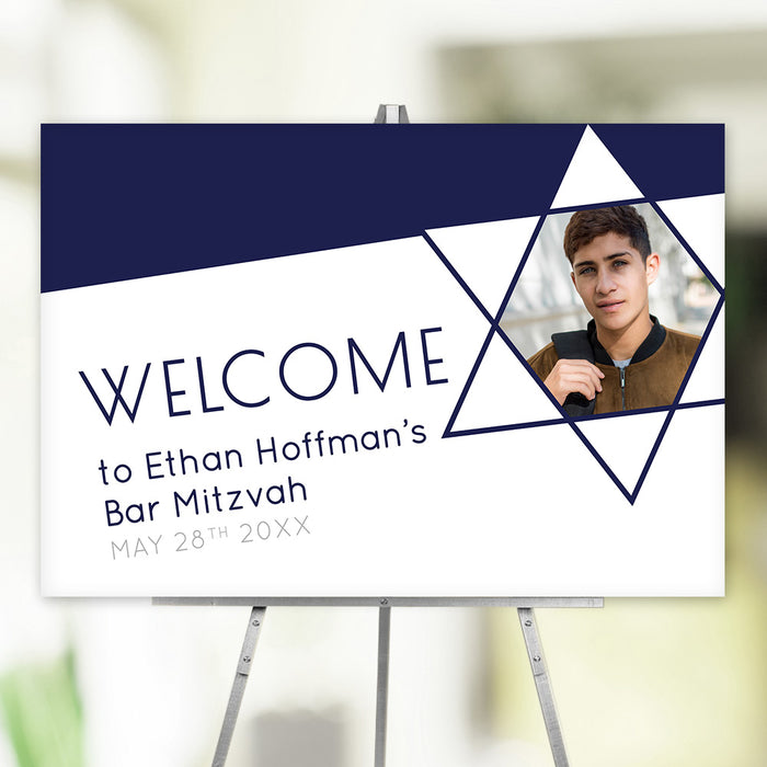 Personalized Bar Mitzvah welcome poster on easel with Star of David frame around boy’s photo.