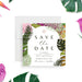Save the date card with tropical leaf design on a white background