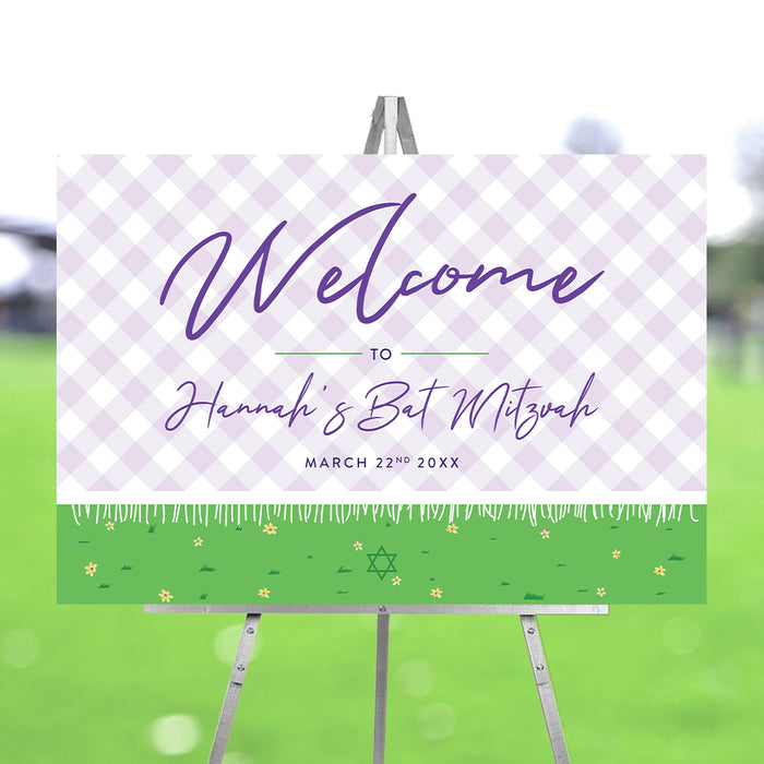 Bat Mitzvah welcome sign with purple check pattern and garden design displayed on an easel for event entrance decor