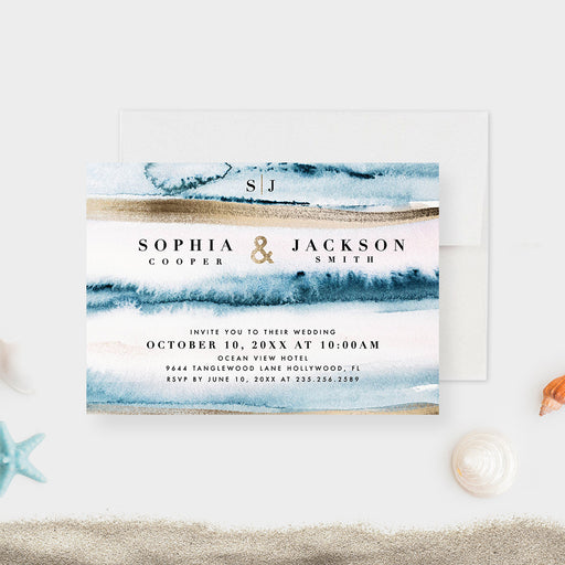 beach destination wedding invitation with blue ocean wave artwork, sand-toned accents, monogram, and coastal wedding details-front