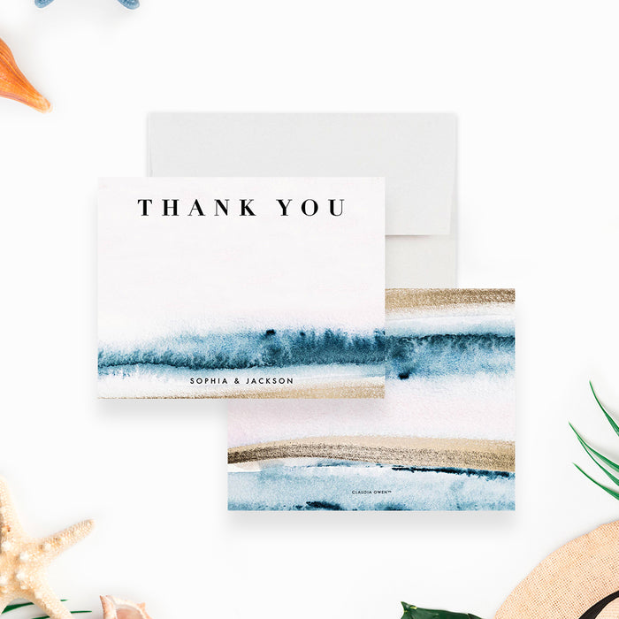 beach wedding thank you card with blue ocean wave artwork, sand-toned accents, couple names, and coastal design-front-back