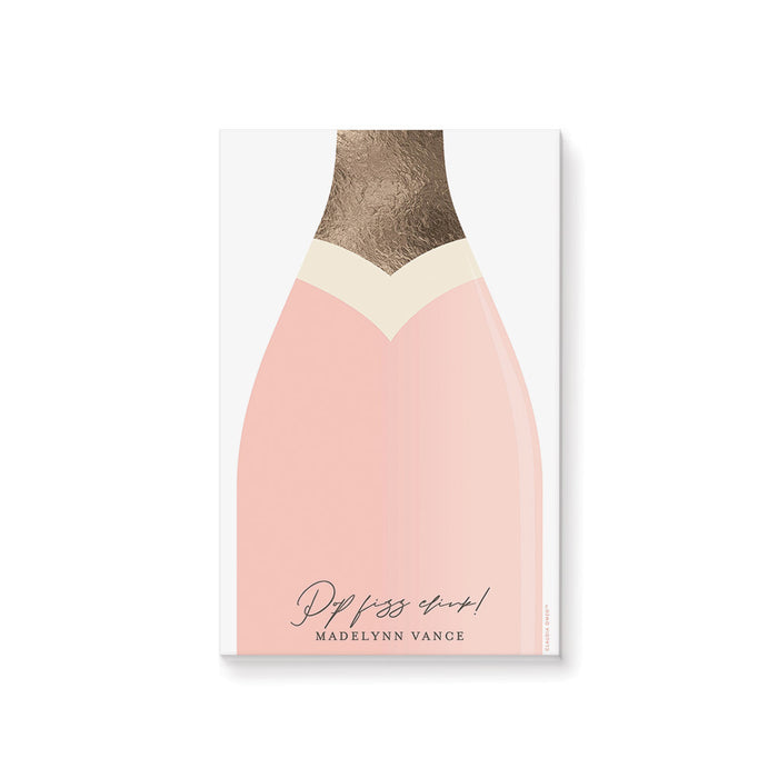 Blush pink champagne bottle notepad with “Pop Fizz Clink!” text, personalized with a name, making it a custom stationery gift or party favor.
