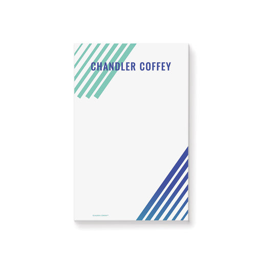 Personalized notepad featuring teal and navy diagonal stripes, with a custom name in bold navy text, designed in a modern stationery style.