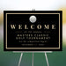 Personalized golf tournament welcome sign with black background, gold border, and golf ball illustration