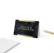 Personalized black marble place cards with gold accents folded into elegant tent name cards for weddings and formal events