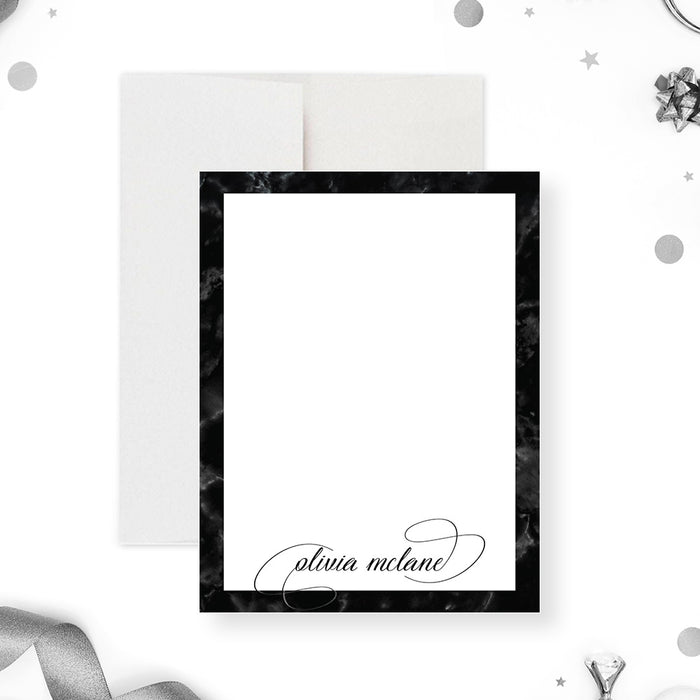 Personalized note card with a white front framed by a black marble border with a personalized script name. Shown with a white envelope.