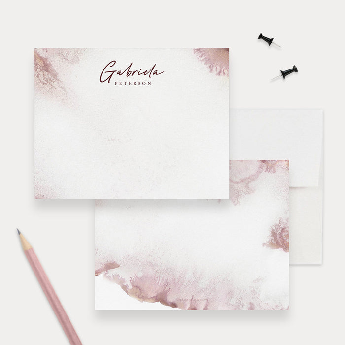 Personalized blush pink watercolor note card front and back, with burgundy script name lettering and white envelopes.