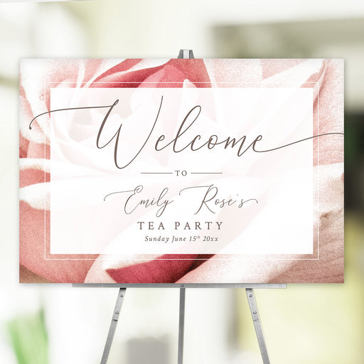 blush rose floral tea party welcome sign with elegant script lettering and personalized event details displayed on an easel