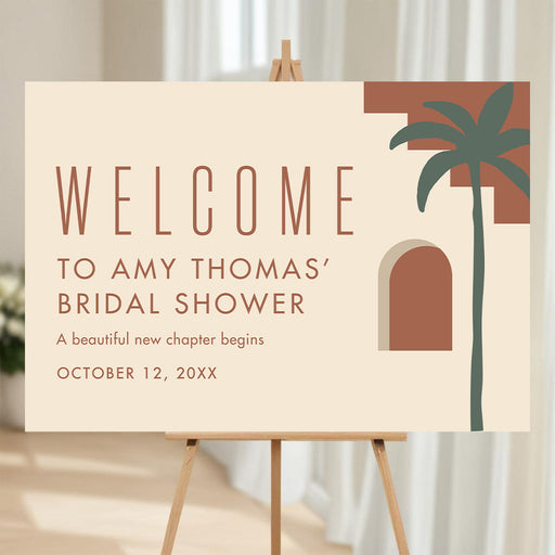 Boho bridal shower welcome sign with terracotta lettering, abstract desert arches, green palm tree, honoree’s name and event date