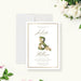 botanical wedding invitation with floral ampersand, elegant script names, classic border, and personalized wedding details-front