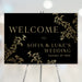 Elegant black and gold welcome sign with botanical accents, personalized event signage for weddings, anniversaries, and special occasions.