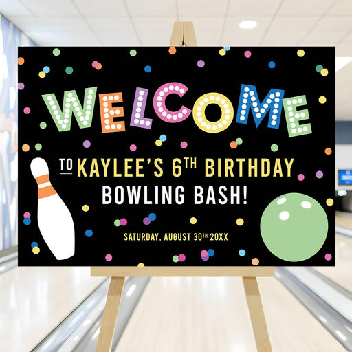 Colorful bowling birthday welcome sign with confetti, bowling pin, and ball design displayed on an easel