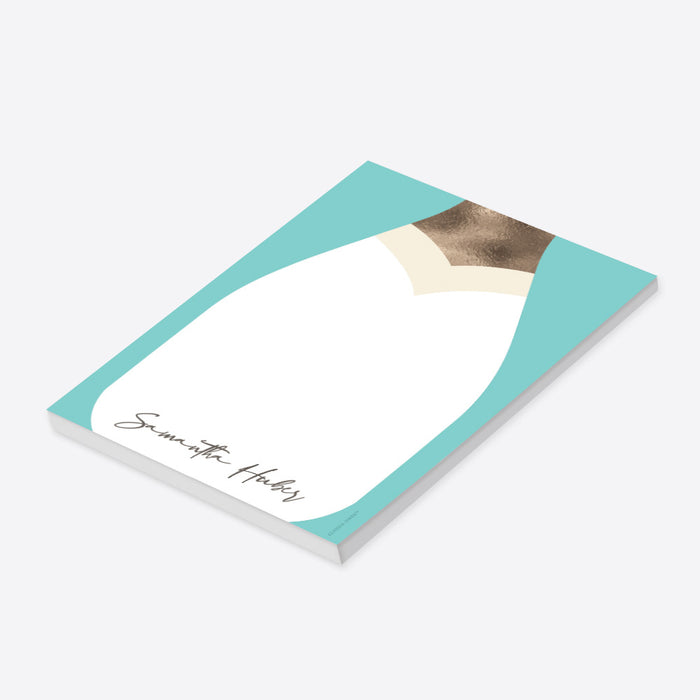 Personalized notepad with a champagne bottle illustration, perfect as a chic bridal shower gift for guests and bridesmaids.-side