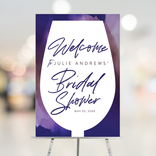Bridal shower welcome sign featuring a wine glass silhouette on a purple watercolor background with custom details.