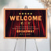 Broadway themed welcome sign with marquee lights and red stage curtain, perfect for theater shows, performances, or glamorous event entrances.